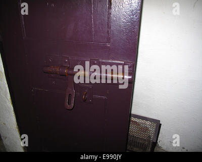 Heavy sliding bolt on old prison door Stock Photo