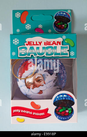 Jelly Bean Bauble with Father Christmas face on in box isolated on blue background Stock Photo