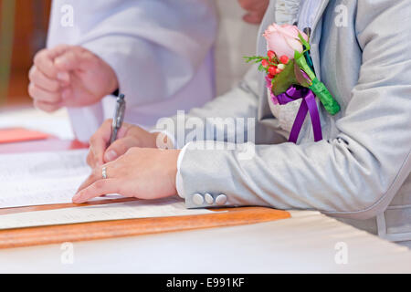 Wedding couple leaving their signatures Stock Photo