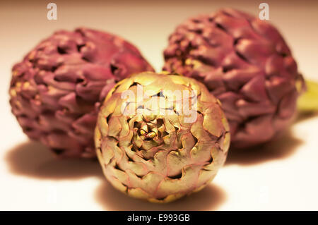 three artichokes isolated Stock Photo