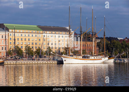 HELSINKI, FINLAND - SEPTEMBER 14, 2014: quay of Helsinki with moored old sailing ships and classical buildings facades in the mo Stock Photo