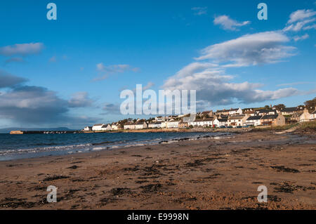 A photograph of Portmahomack, Easter Ross, Scotland, taken along the beach showing the town and harbour Stock Photo
