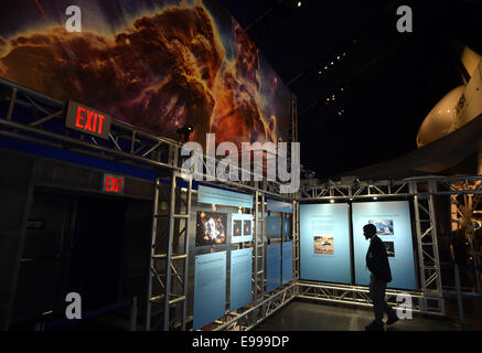 New York, USA. 22nd Oct, 2014. A reporter attends the press preview of a new exhibit named 'HUBBLE@25', which is to celebrate the 25th anniversary of NASA's launch of the Hubble Space Telescope, at the Intrepid Sea, Air & Space Museum in New York City, the United States, Oct. 22, 2014. Through the images produced by Hubble, tools used in space to repair the telescope, and interactive guests' experiences, the exhibit will open to the public on Thursday and tell the story of Hubble's 25-year history. Credit:  Wang Lei/Xinhua/Alamy Live News Stock Photo