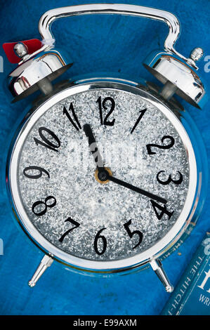 Used alarm clock on blue tarpaulin at car boot sale, Burry Port, Carmarthenshire, west Wales. Stock Photo