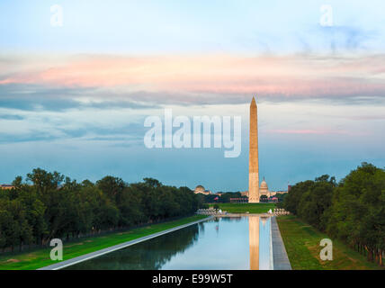 Setting sun on Washington monument reflecting Stock Photo