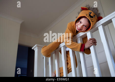 Boy in lion suit on stair Stock Photo
