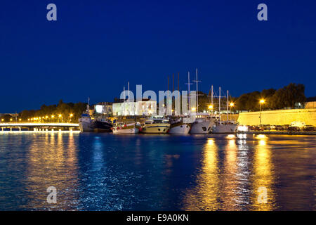 Fishing boats in safe harbor on evening Stock Photo