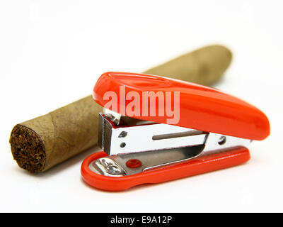 Red stapler and cigar Stock Photo