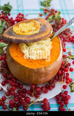 Dairy millet porridge baked in  pumpkin Stock Photo