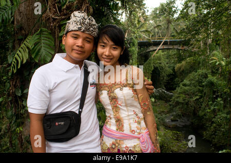 A couple in front of the temple Pura Gunung Lebah. Ubud. Bali. Gunung Lebah was constructed in the 8th century by Danghyang Mark Stock Photo