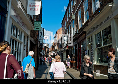 People tourists walking along narrow medieval street of the Shambles in summer York city town centre North Yorkshire England UK United Kingdom Britain Stock Photo
