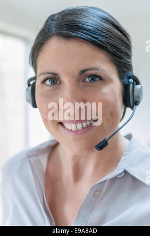 Customer Service Representative talking on headset Stock Photo