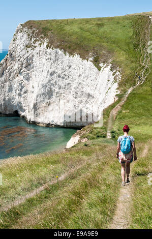 Young female hiker walks the Jurassic Coastline, Dorset, Great Britain Stock Photo