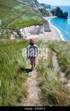 Young female hiker walks the Jurassic Coastline, Dorset, Great Britain Stock Photo