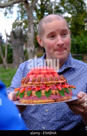 London, UK. 23rd Oct, 2014. Richard Burr from the Great British bake off with the cake he made for Zaire's birthday Credit:  Rachel Megawhat/Alamy Live News Stock Photo