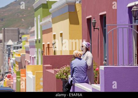 local woman and their typical coloured homes in the quarter Cape Malay Bo-Kaap, Cape Town, Western Cape, South Africa Stock Photo