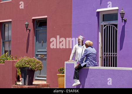 local woman and their typical coloured homes in the quarter Cape Malay Bo-Kaap, Cape Town, Western Cape, South Africa Stock Photo