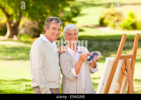 Senior couple painting in the park Stock Photo