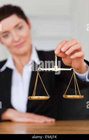 Serious woman holding the justice scale Stock Photo
