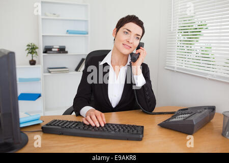 Secretary answering the phone Stock Photo