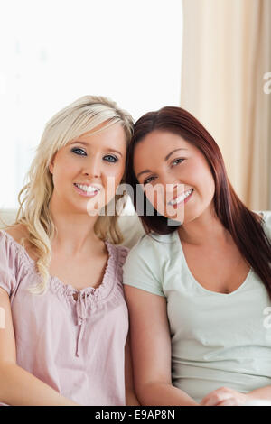Cheerful women lounging on a sofa Stock Photo