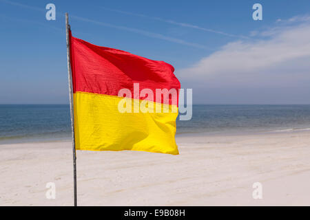 A red-yellow flag waves on the beach, near Kampen, Sylt, Schleswig-Holstein, Germany