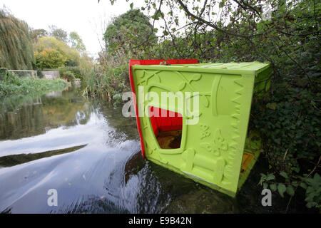 A child's Wendy house dumped in the River Wylye in the Wiltshire countryside, UK Stock Photo
