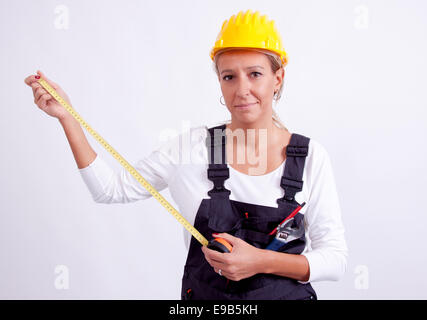 Female construction worker with tools on white background Stock Photo