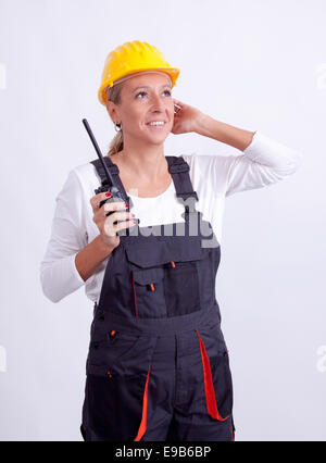 Female construction worker with tools on white background Stock Photo