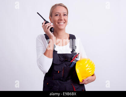 Female construction worker with tools on white background Stock Photo