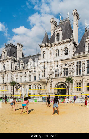 people playing volleyball on a artificial urban beach in front of the paris city hall within the so-called paris plages project Stock Photo