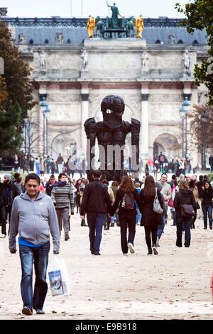 Paris, France. 23rd Oct, 2014. People pass by a piece of art entitled 'Giant Figure (Cyclops)' by Thomas Houseago which is displayed at the 'outside the walls' exhibition of the 41st International Contemporary Art Fair (FIAC) in the Tuilleries Garden in Paris, France, Oct. 23, 2014. The FIAC runs from Oct. 23 to Oct. 26. Credit:  Etiene Laurent/Xinhua/Alamy Live News Stock Photo