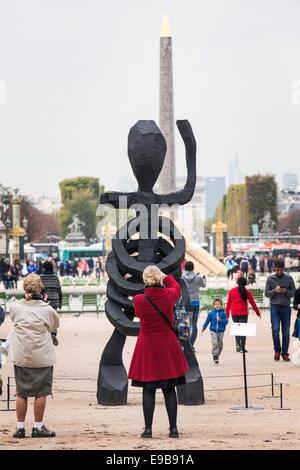 Paris, France. 23rd Oct, 2014. People gather around a piece of art entitled 'Louise Fuller' by Georg Baselitz which is displayed at the 'outside the walls' exhibition of the 41st International Contemporary Art Fair (FIAC) in the Tuilleries Garden in Paris, France, Oct. 23, 2014. The FIAC runs from Oct. 23 to Oct. 26. Credit:  Etiene Laurent/Xinhua/Alamy Live News Stock Photo