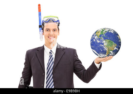 Businessman with diving mask holding the earth and standing isolated on white background, Stock Photo