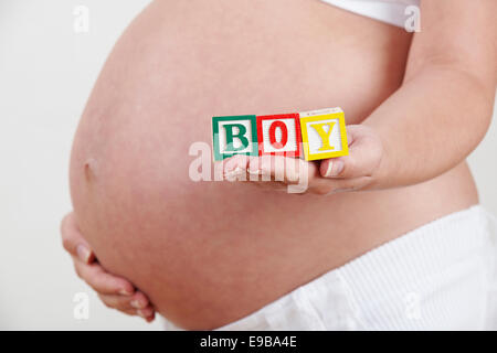 Pregnant Woman Holding Wooden Blocks Spelling Boy Stock Photo