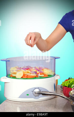 Chef cuts the vegetables in a steamer Stock Photo