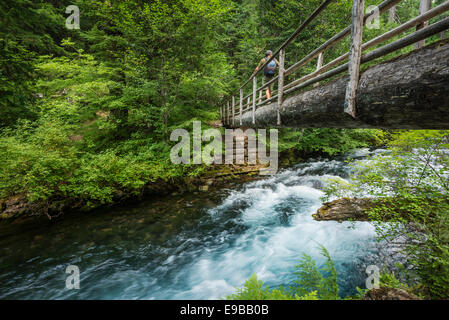 Hiker On A River Bridge Stock Photo - Alamy