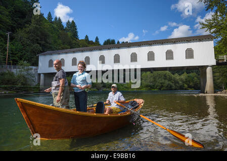 Drift boat fishing on the McKenzie River at Goodpasture Bridge with guide Greg Hatten and Wooden Boat Adventures; Lane County, O Stock Photo