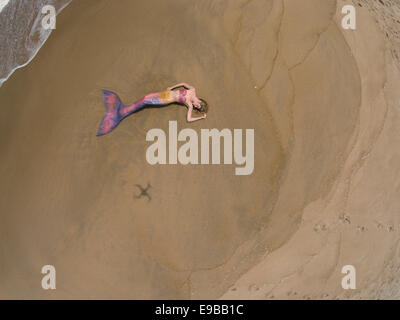 Aerial drone photo of a mermaid laying in the sand on the beach in Virginia Beach, Virginia Stock Photo