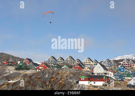 Man parasailing over homes in Nuuk, Greenland Stock Photo