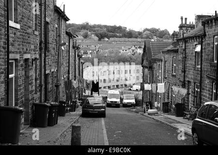 Back to back terraced houses with washing strung across the road in Ingrow, West Yorkshire Stock Photo