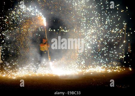 A fairground performer twirls a firework baton Stock Photo