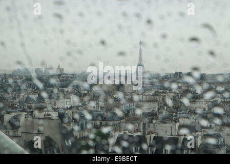 Rain drops in focus and skyline of Paris, including Eiffel Tower in background. Showery day in June. from Centre Pompidou,Paris, Stock Photo