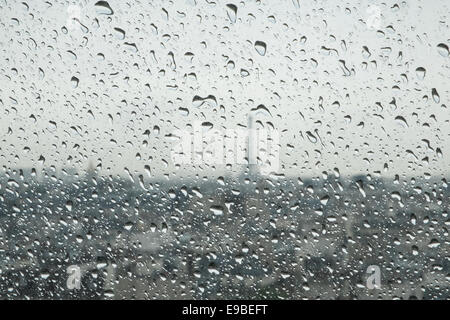 Rain drops in focus and skyline of Paris, including Eiffel Tower in background. Showery day in June. from Centre Pompidou,Paris, Stock Photo