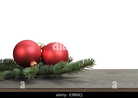 traditional red balls and fir branch on wood table, white background Stock Photo