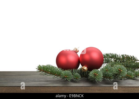 traditional red balls and fir branch on wood table, white background Stock Photo