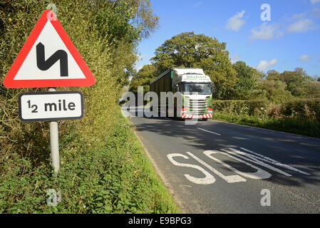 lorry passing sharp bend warning sign for half a mile ahead yorkshire united kingdom Stock Photo