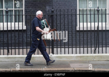 Westminster London, UK. 24 October 2014. A worker walks out of 10 Downing with a chair to be reupholstered Credit:  amer ghazzal/Alamy Live News