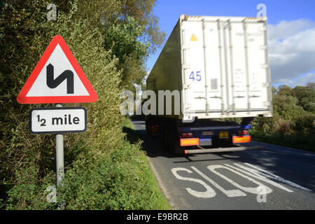 lorry passing sharp bend warning sign for half a mile ahead yorkshire united kingdom Stock Photo