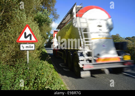 lorry passing sharp bend warning sign for half a mile ahead yorkshire united kingdom Stock Photo